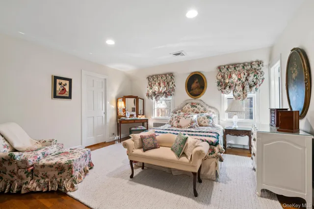 a spacious bedroom with a bed and a table in it