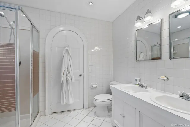 a front view of a house with a yard and potted plants