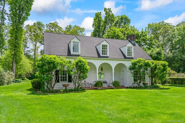 a view of a patio with a table and chairs under an umbrella