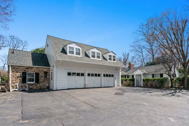 a view of a house with a big yard and potted plants