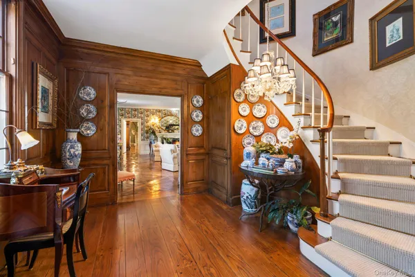 a view of entryway and hall with wooden floor