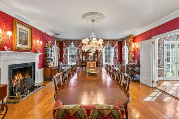 a dining room with furniture window and wooden floor