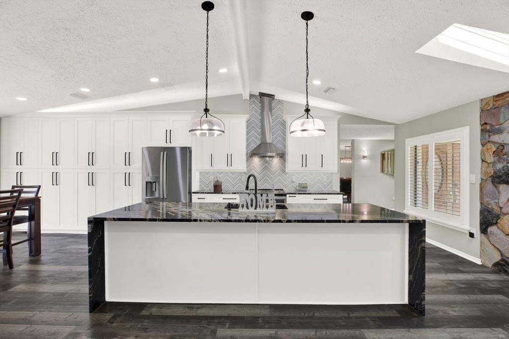 7487 River Country Drive Weeki Wachee, FL 34607 - Photo 16 of 53 a large kitchen with kitchen island a large island in the center