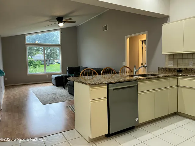 a kitchen with a sink cabinets and window