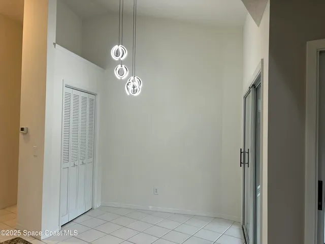 en view of a hallway with chandelier