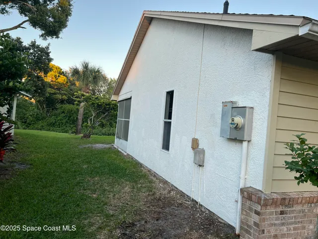 a brick house with a tree in front of it