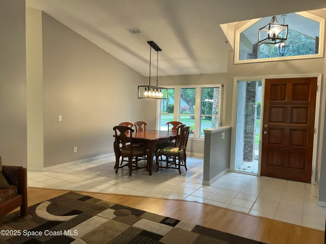 a view of a dining room with furniture and chandelier