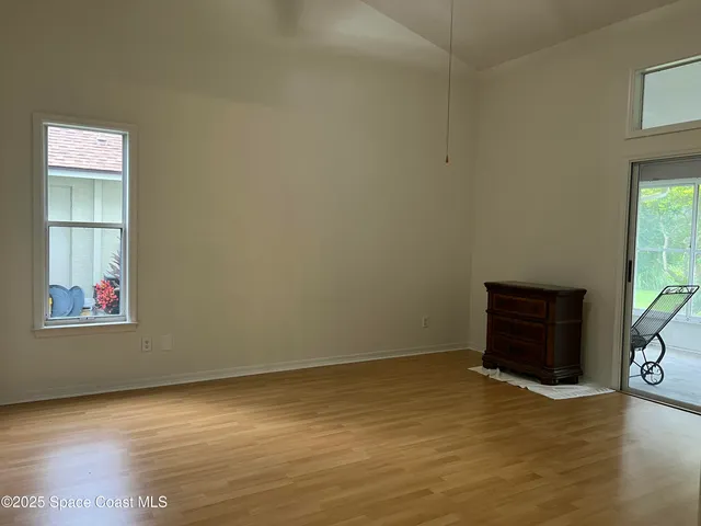 an empty room with windows and entrance