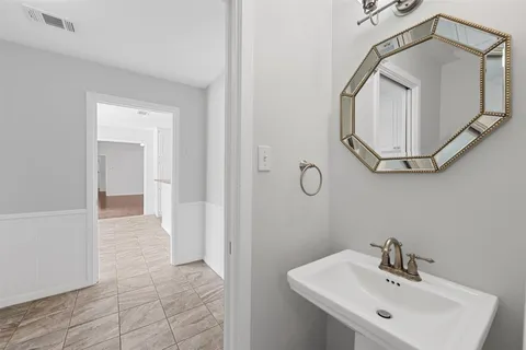 a bathroom with a sink a mirror and vanity