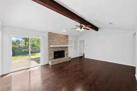 wooden floor in an empty room with a fireplace