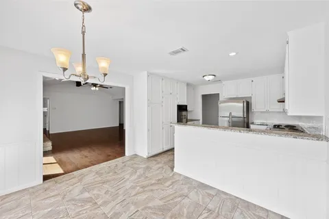 a view of kitchen with refrigerator stove and microwave