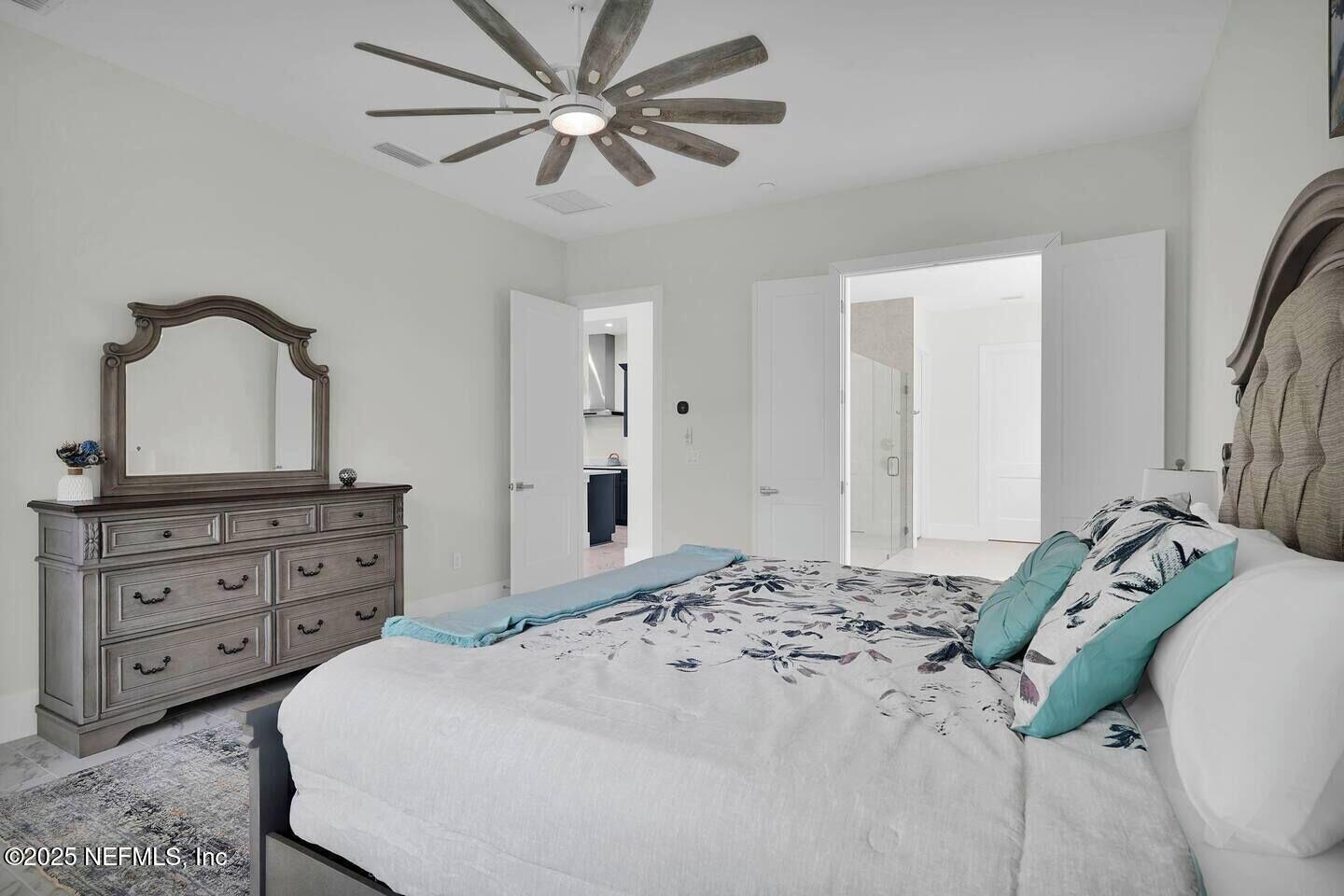 586 A1A North Ponte Vedra Beach, FL 32082 - Photo 16 of 29 a bedroom with a bed and a dresser