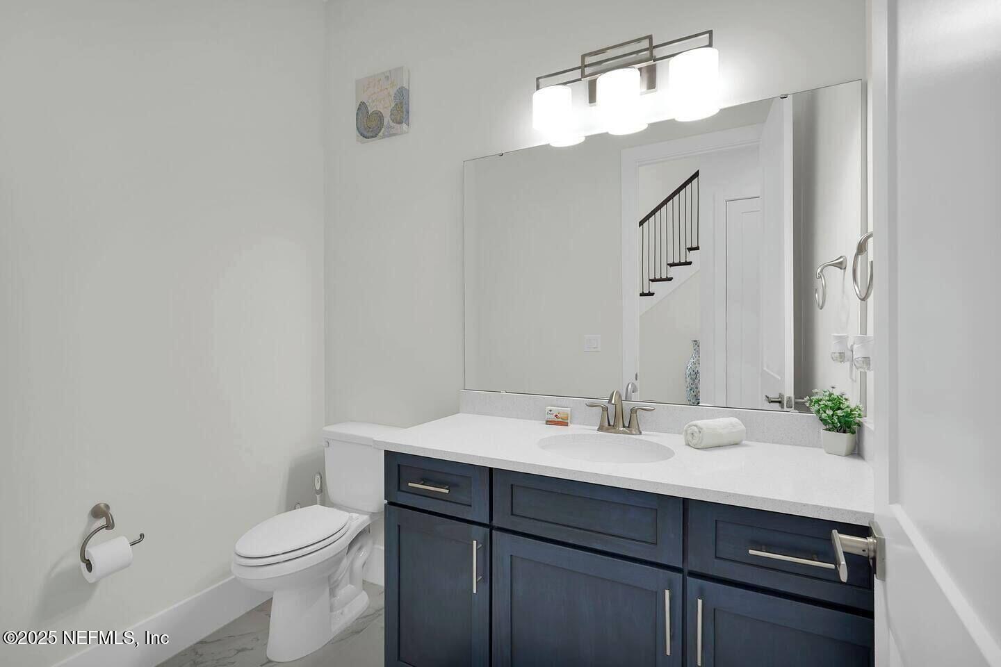 586 A1A North Ponte Vedra Beach, FL 32082 - Photo 19 of 29 a bathroom with a sink a toilet and mirror