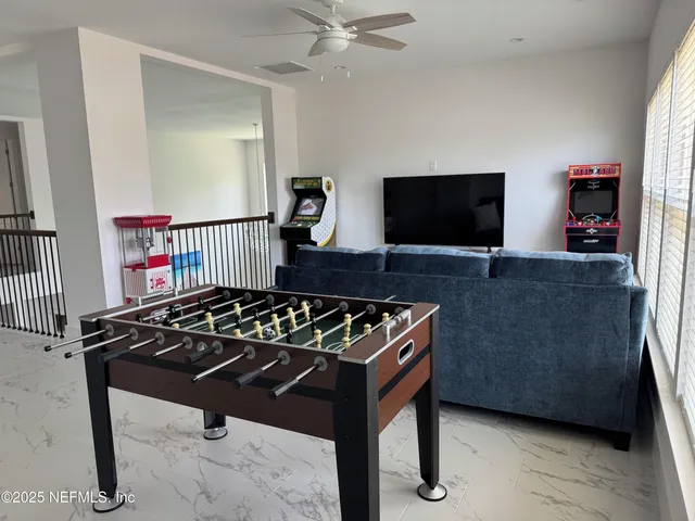 a living room with couch and a flat screen tv