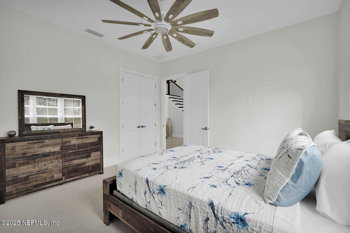 586 A1A North Ponte Vedra Beach, FL 32082 - Photo 23 of 29 a bedroom with a bed and a chandelier