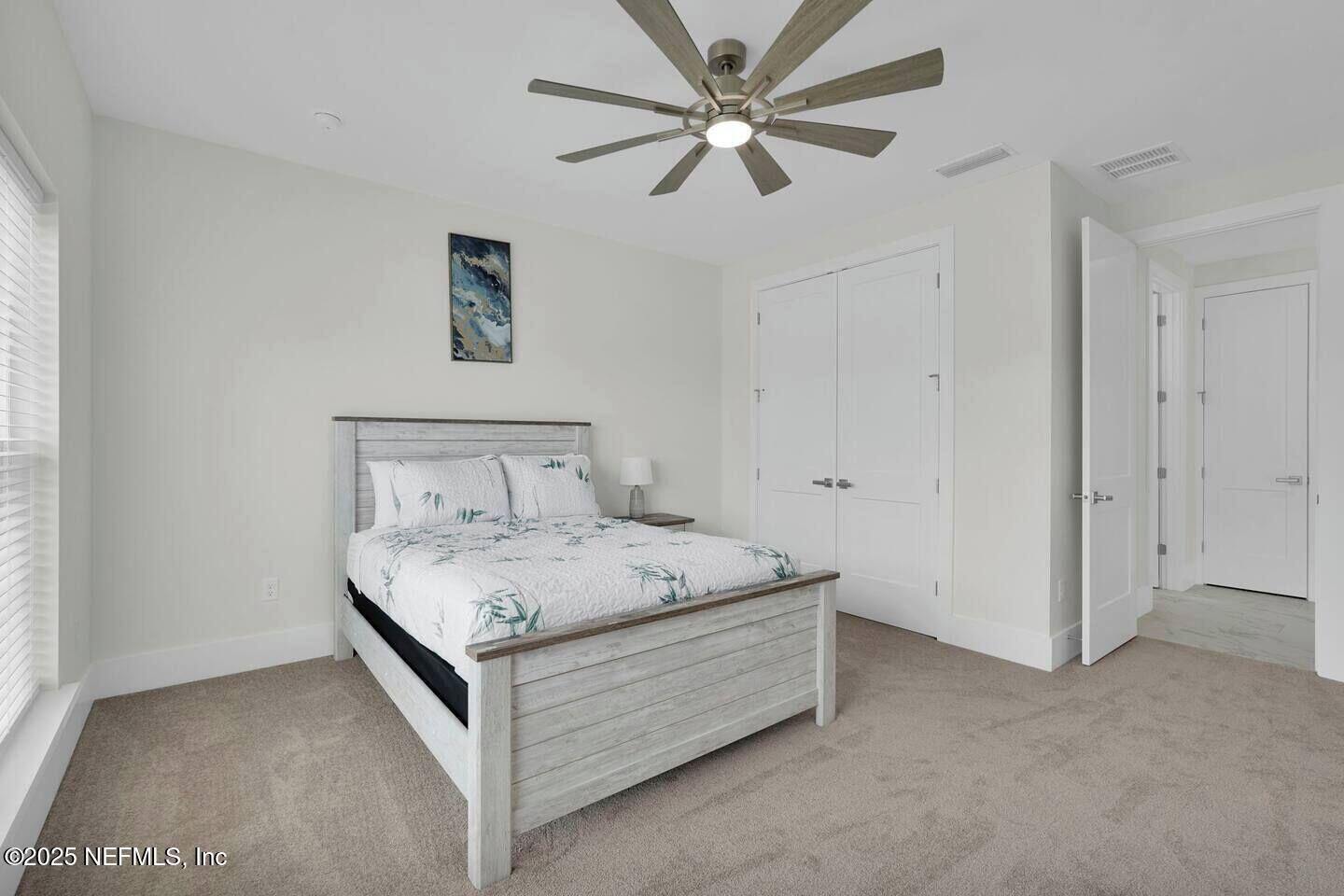 586 A1A North Ponte Vedra Beach, FL 32082 - Photo 24 of 29 a bed sitting in a spacious bedroom and night stand