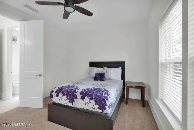 a bedroom with a bed and window