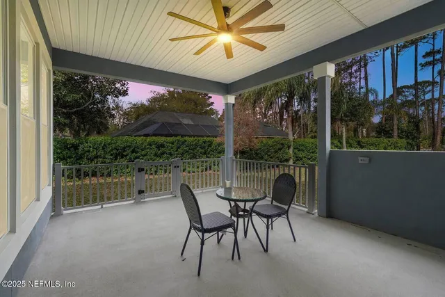 a dining room with furniture and a floor to ceiling window