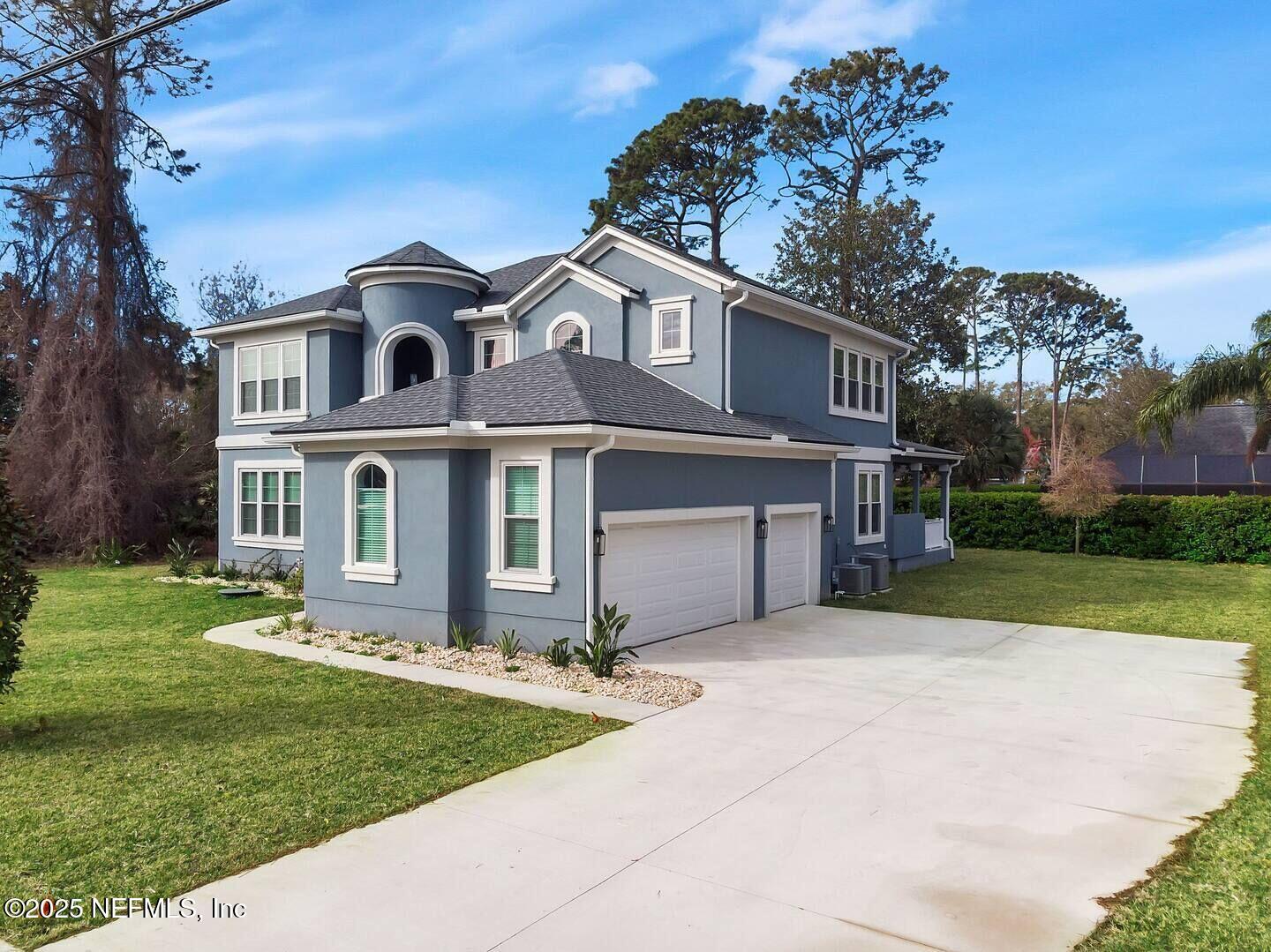 586 A1A North Ponte Vedra Beach, FL 32082 - Photo 4 of 29 a front view of a house with a yard and garage