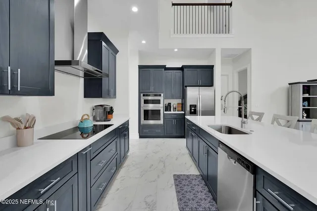 a kitchen with stainless steel appliances a sink stove top oven and cabinets