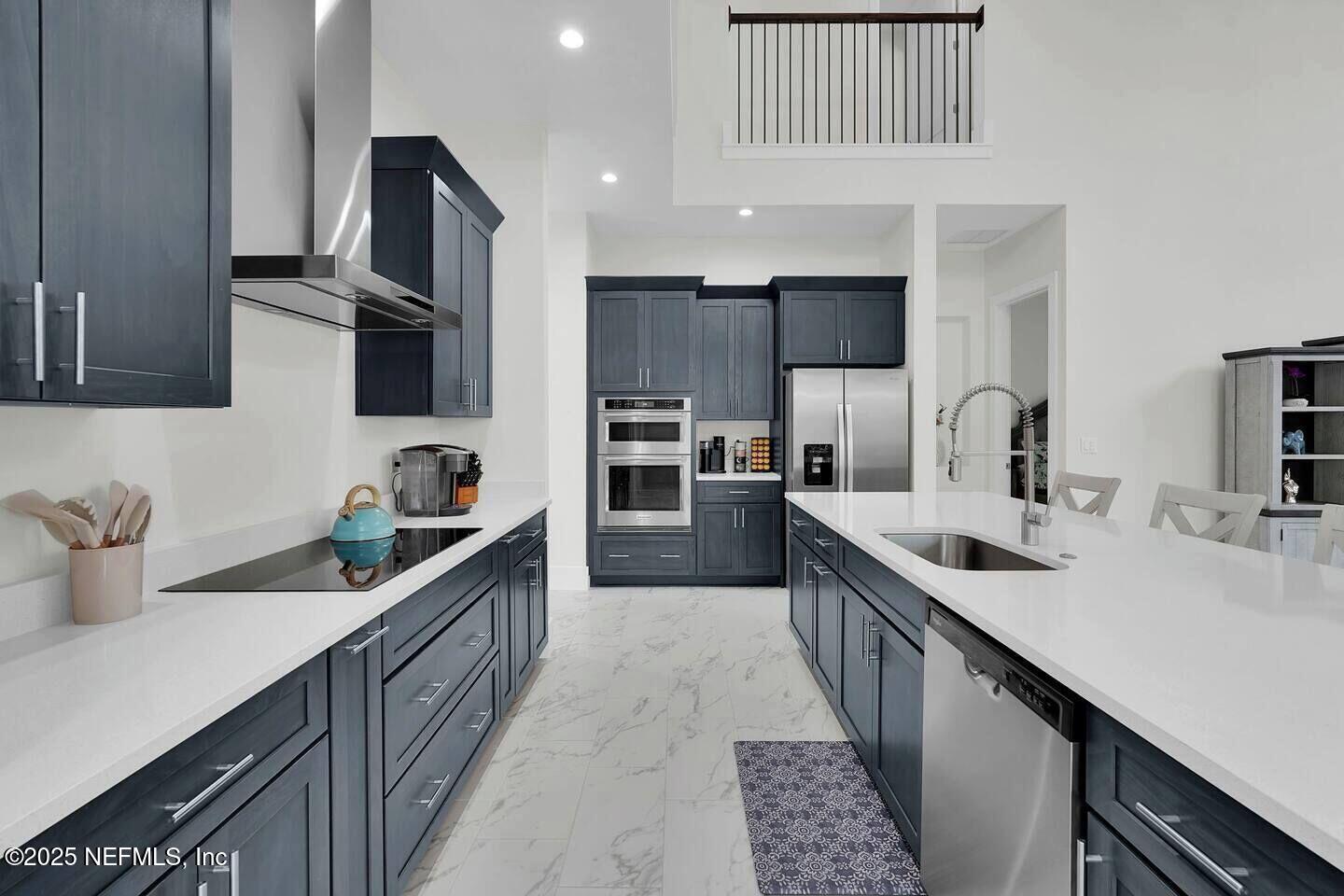 586 A1A North Ponte Vedra Beach, FL 32082 - Photo 6 of 29 a kitchen with stainless steel appliances a sink stove top oven and cabinets