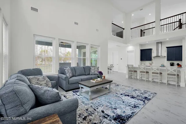 a living room with furniture couches and a flat screen tv