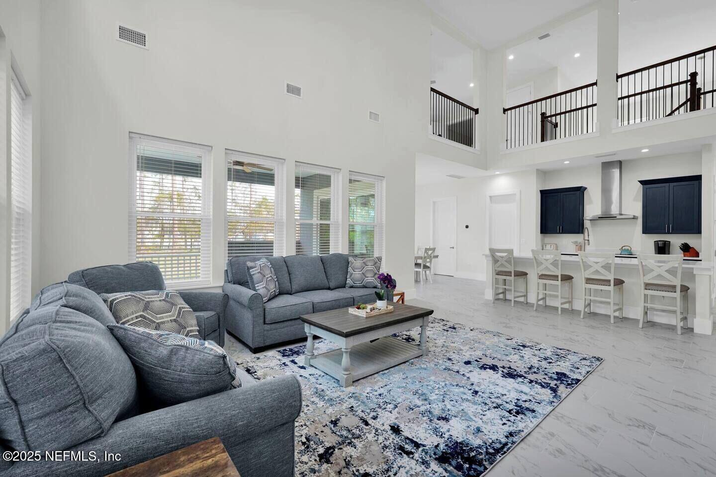586 A1A North Ponte Vedra Beach, FL 32082 - Photo 7 of 29 a living room with furniture couches and a flat screen tv