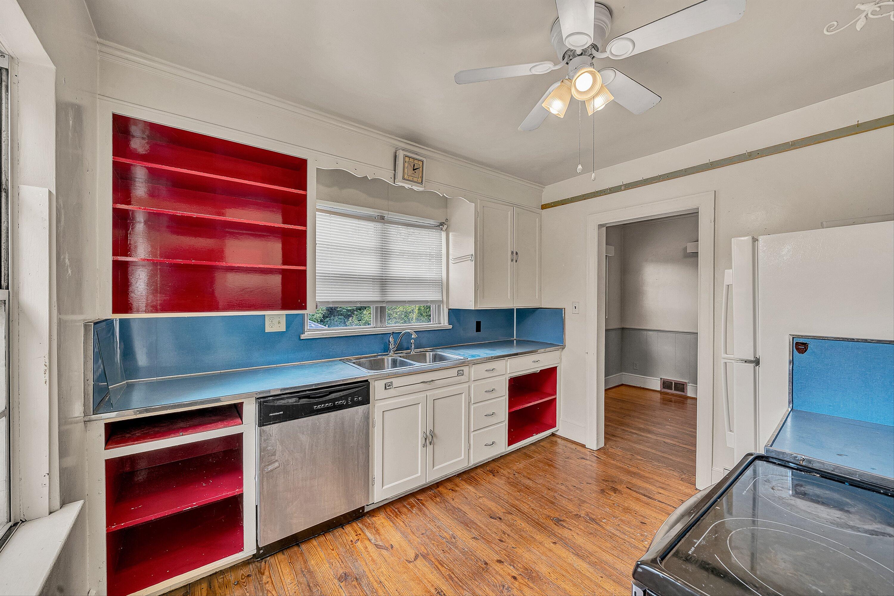 1917 Langdon Road Southwest Roanoke, VA 24015 - Photo 10 of 42 a kitchen with stainless steel appliances granite countertop a sink cabinets and wooden floor