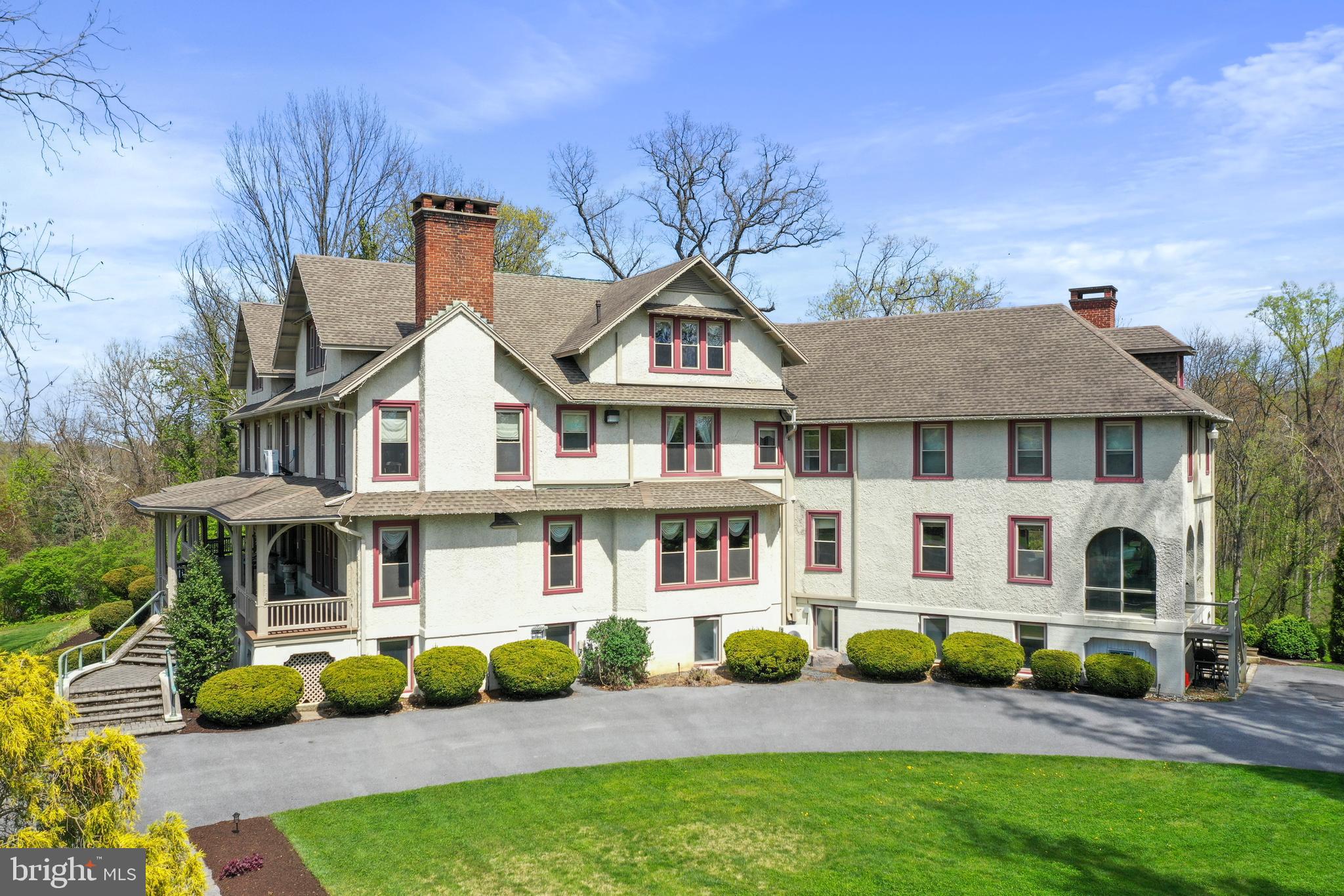 a front view of residential houses with yard and seating space
