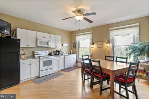 1090 Ragged Edge Road Chambersburg, PA 17202 - Photo 52 of 93 a kitchen with refrigerator cabinets dining table and chairs