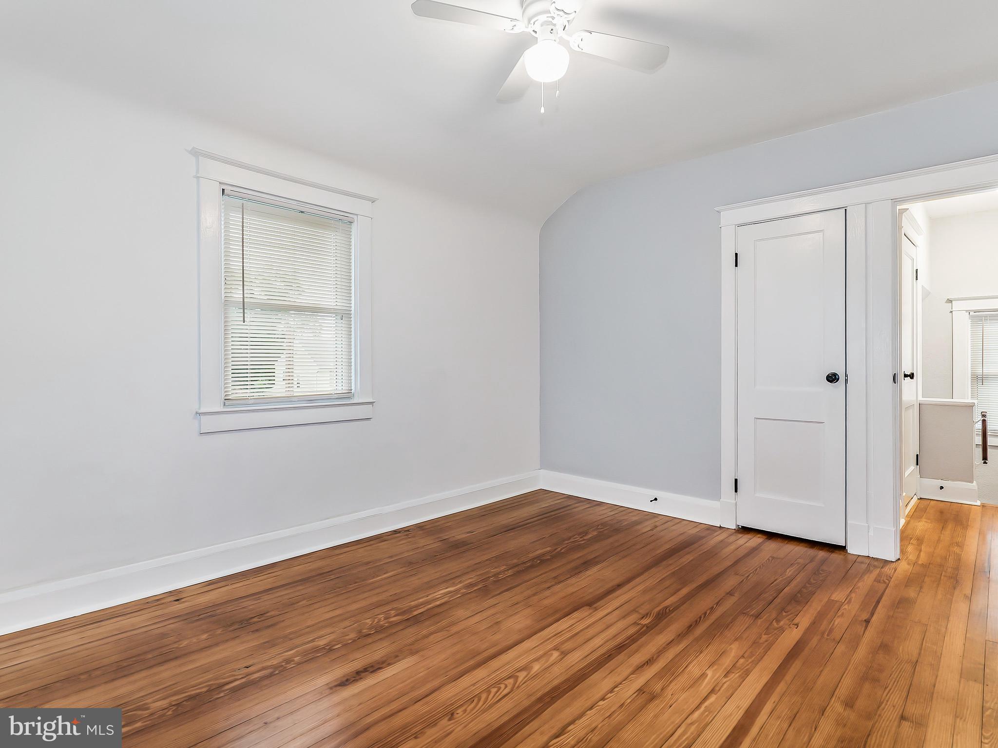 5528 Ashbourne Road Baltimore, MD 21227 - Photo 18 of 30 a view of empty room with wooden floor and fan