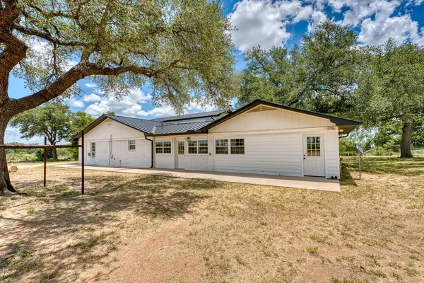 a view of a backyard with a tree
