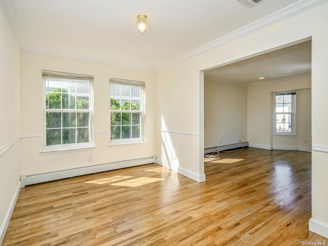 34 Firwood Road, Unit B Port Washington, NY 11050 - Photo 4 of 25 a view of an empty room with wooden floor and a window