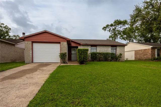 a view of an empty room with a fireplace and windows
