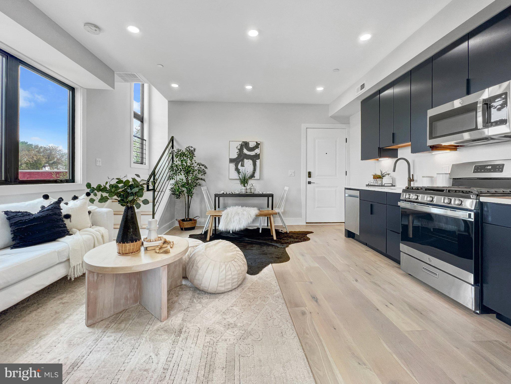 a living room with furniture a fireplace and a potted plant