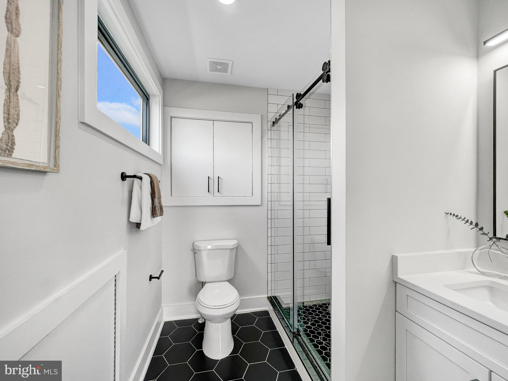 1026 18th Street Northeast, Unit PH7 Washington, DC 20002 - Photo 13 of 21 a bathroom with a toilet sink and shower