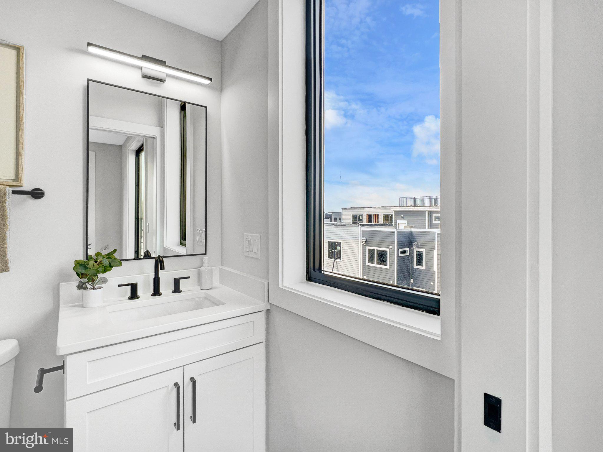 1026 18th Street Northeast, Unit PH7 Washington, DC 20002 - Photo 8 of 21 a bathroom with a sink and a mirror