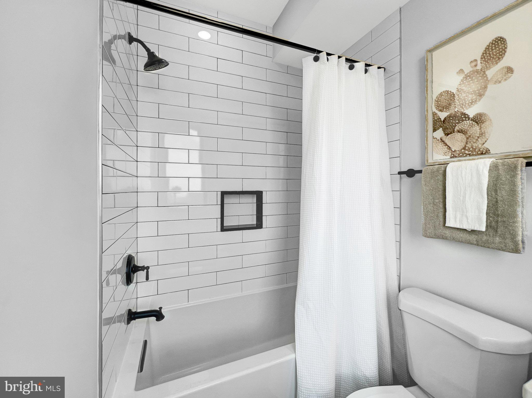 1026 18th Street Northeast, Unit PH7 Washington, DC 20002 - Photo 9 of 21 a bathroom with a shower and a toilet