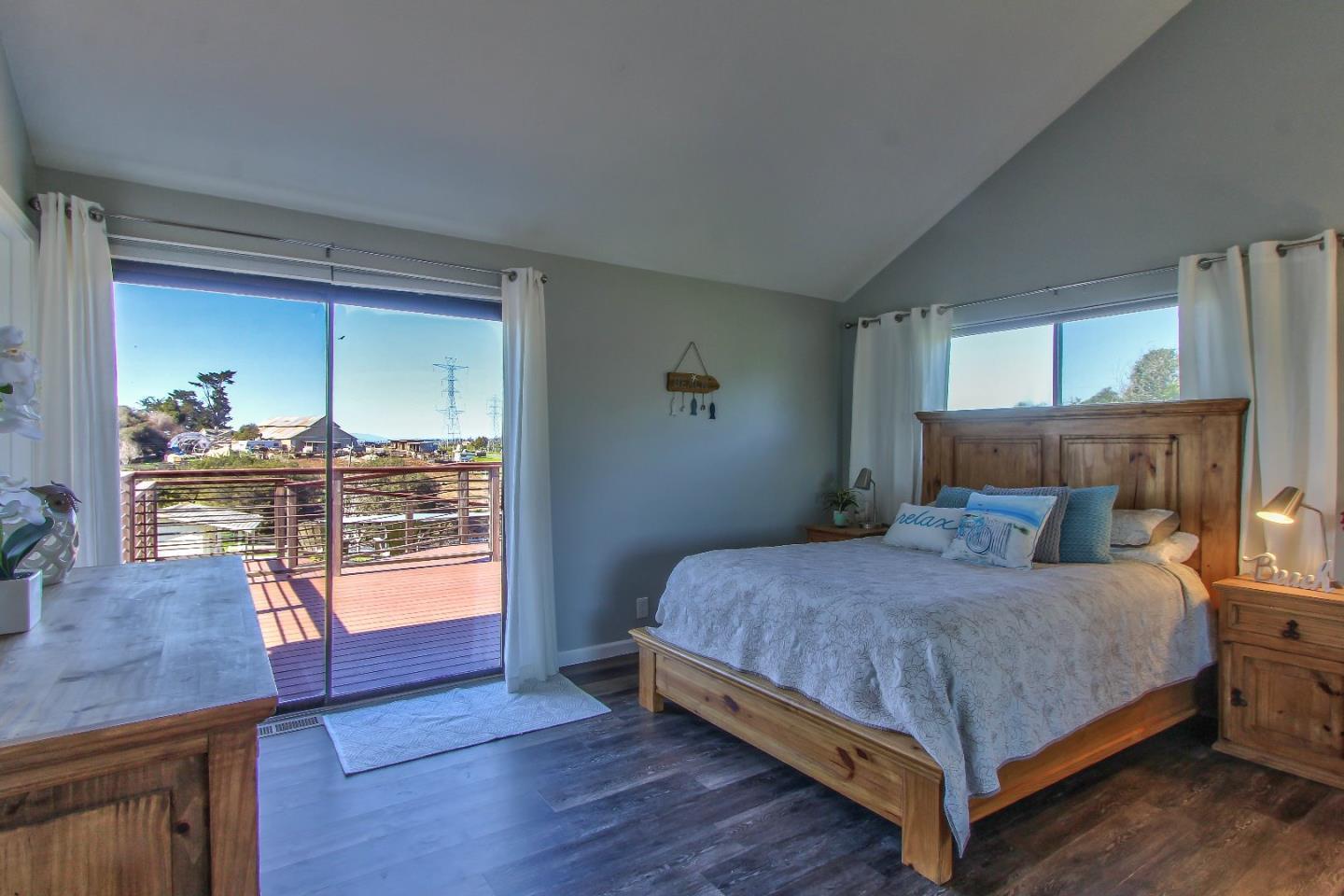 8623 Ormart Road Castroville, CA 95012 - Photo 11 of 34 a bedroom with a bed and wooden floor