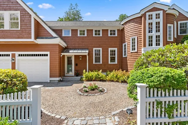 a front view of a house with a yard and outdoor seating