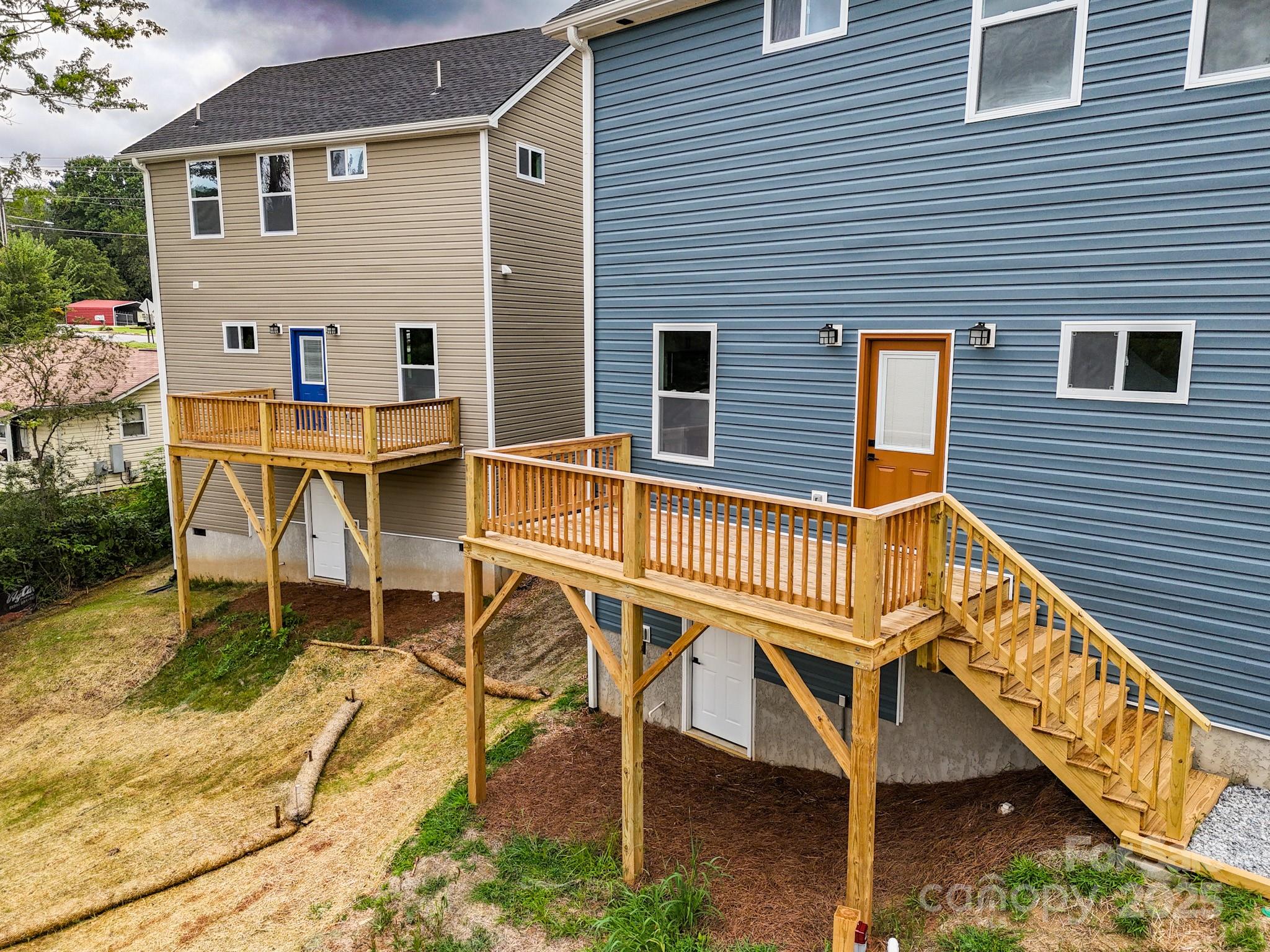 396 Deaverview Road Asheville, NC 28806 - Photo 33 of 35 a view of a house with wooden deck and furniture