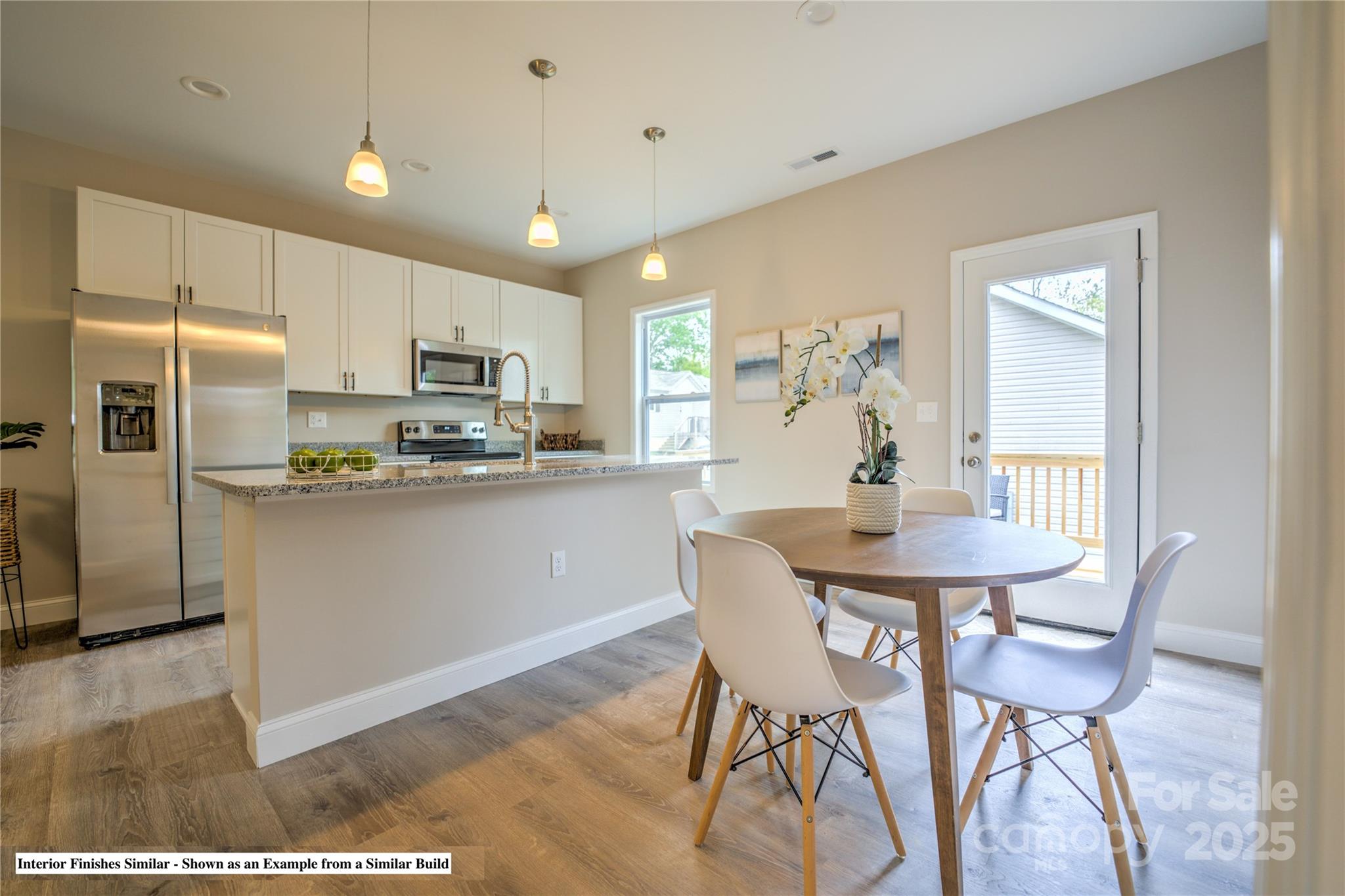 396 Deaverview Road Asheville, NC 28806 - Photo 10 of 35 a kitchen with stainless steel appliances a dining table chairs refrigerator and sink