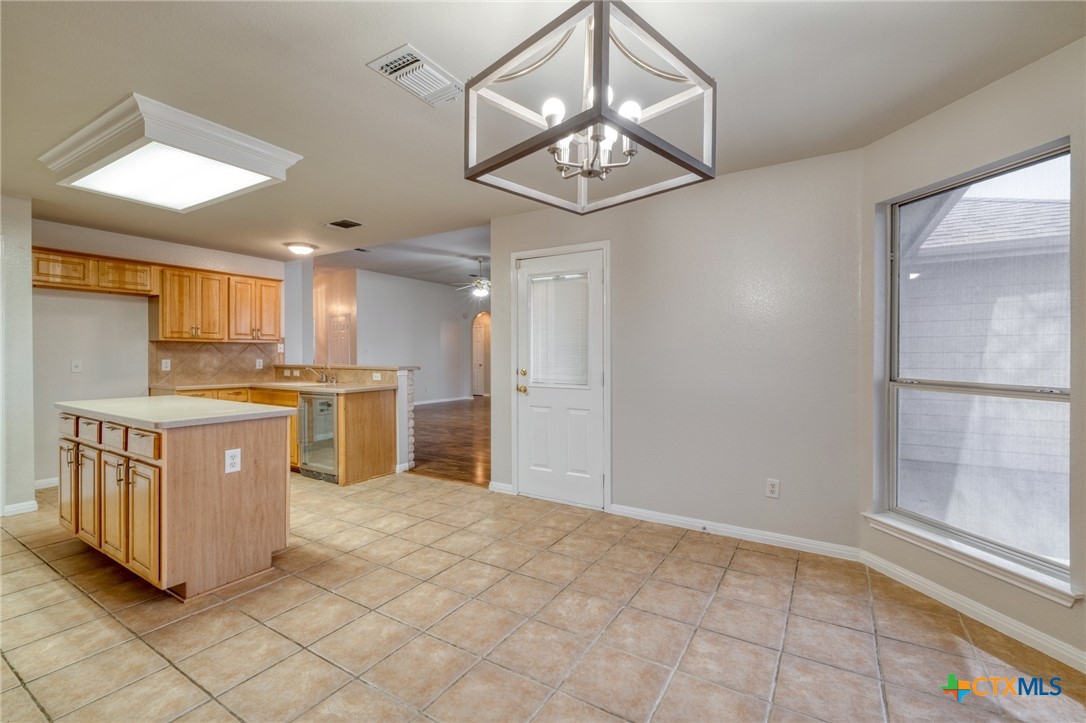 513 South Mockingbird Lane Lockhart, TX 78644 - Photo 11 of 25 a kitchen with cabinets and window