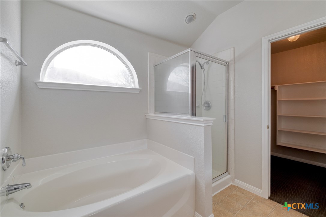 513 South Mockingbird Lane Lockhart, TX 78644 - Photo 17 of 25 a white bath tub sitting next to a window