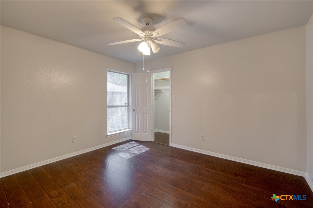 513 South Mockingbird Lane Lockhart, TX 78644 - Photo 20 of 25 an empty room with wooden floor and windows