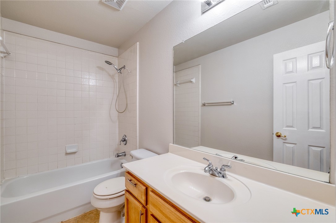 513 South Mockingbird Lane Lockhart, TX 78644 - Photo 21 of 25 a bathroom with a sink toilet and shower