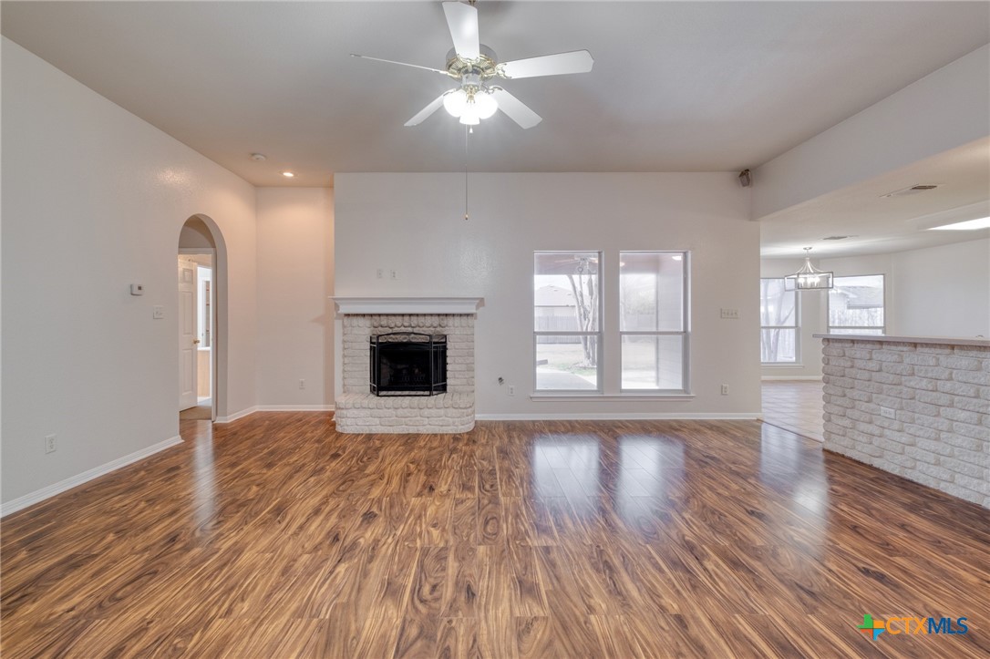 513 South Mockingbird Lane Lockhart, TX 78644 - Photo 5 of 25 a view of an empty room with wooden floor and a fireplace