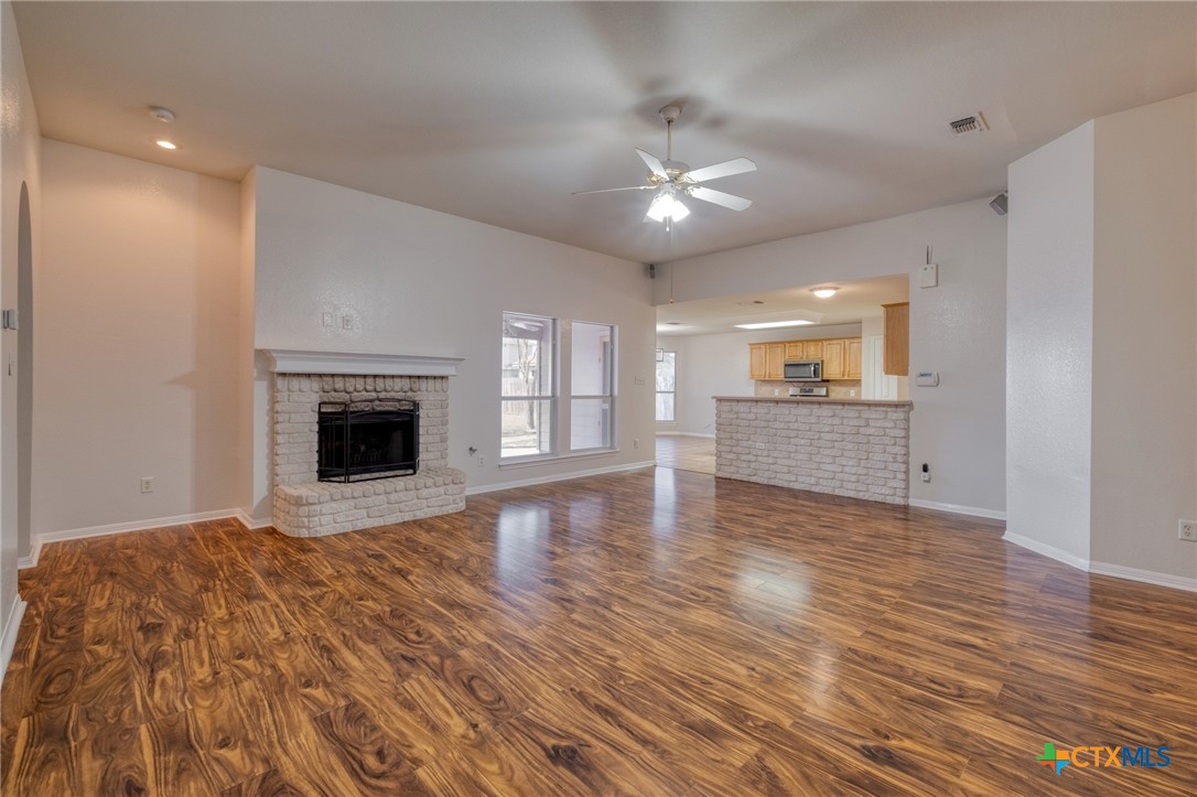 513 South Mockingbird Lane Lockhart, TX 78644 - Photo 6 of 25 a view of empty room with wooden floor and fireplace