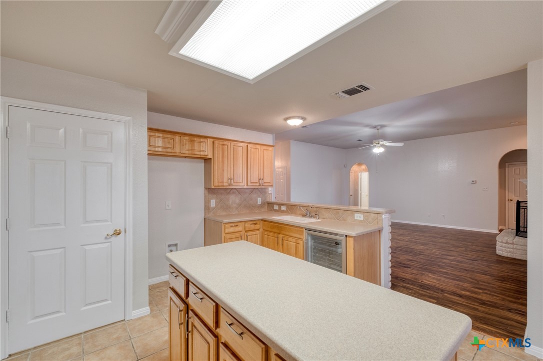 513 South Mockingbird Lane Lockhart, TX 78644 - Photo 9 of 25 a kitchen with a stove a sink and a refrigerator