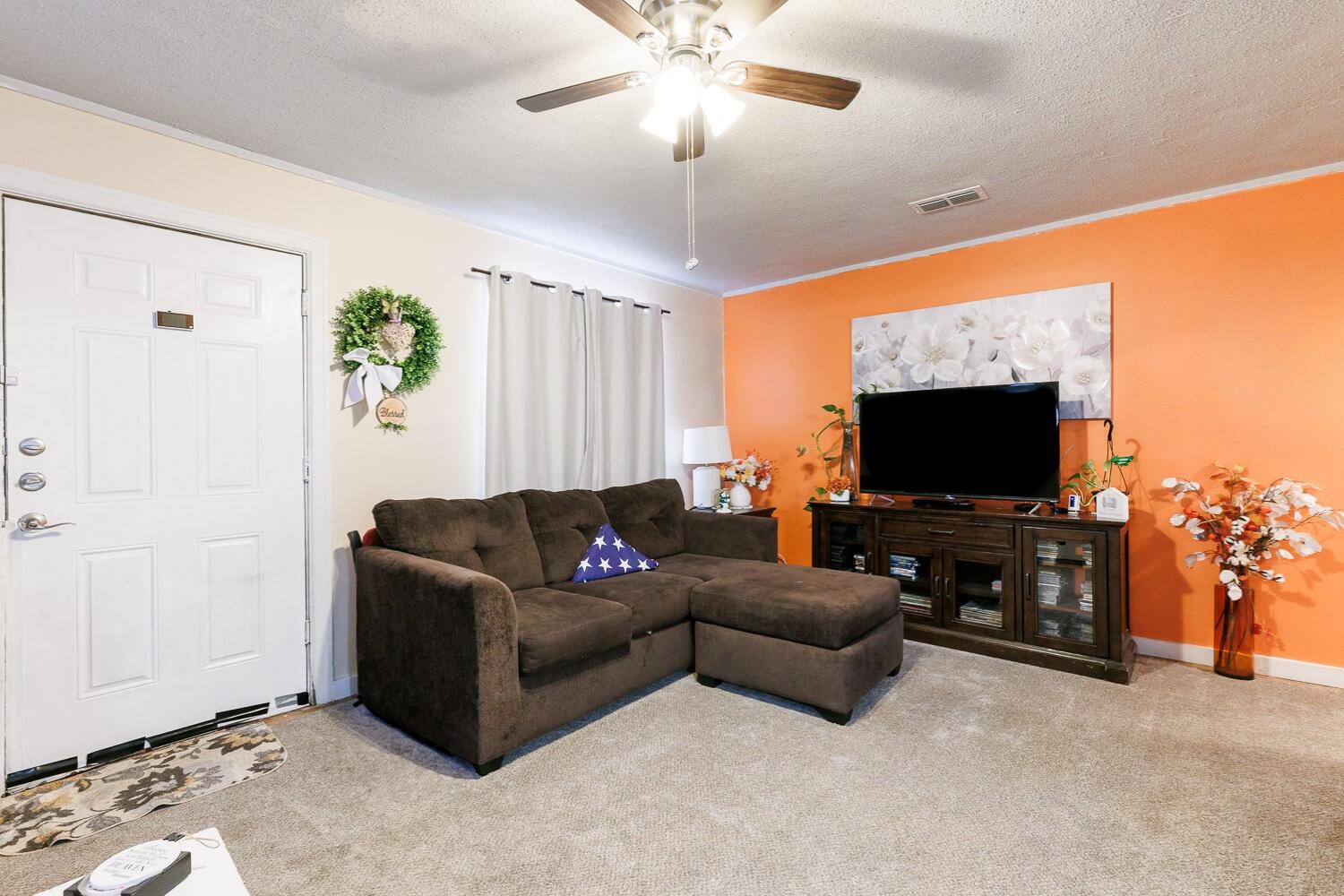 2004 26th Street Lubbock, TX 79411 - Photo 5 of 16 a living room with furniture and a flat screen tv